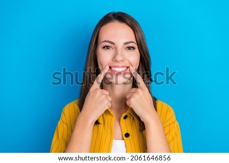 Photo of young pretty woman point fingers teeth dentist oral care stomatology isolated over blue color background Foto d'archivio © 