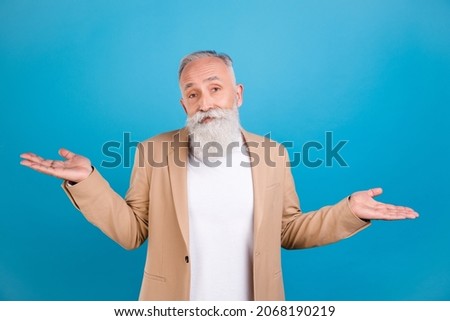 Portrait of attractive puzzled classy grey-haired man shrugging shoulders no answer isolated over bright blue color background Foto stock © 