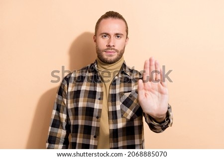 Photo of young handsome guy show arm stop ban denial symbol reject isolated over beige color background Stock fotó © 