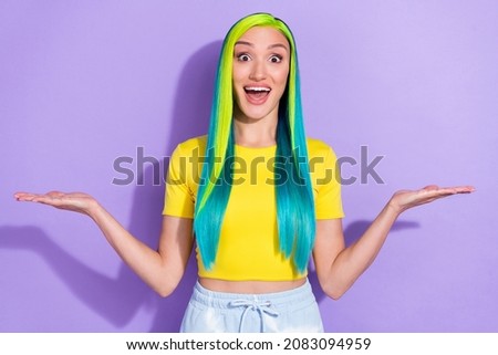 Portrait of beautiful amazed girl advertise product compare products vs scales isolated on violet color background Photo stock © 