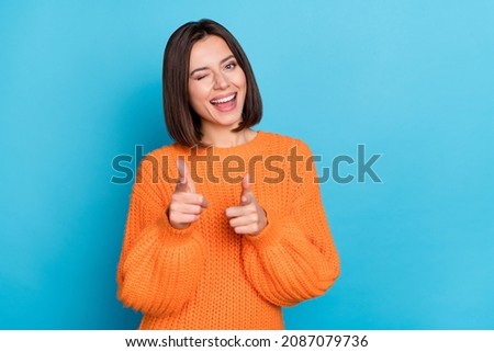 Portrait of attractive flirty funny cheerful girl winking pointing forefingers at you isolated over vibrant blue color background Foto stock © 