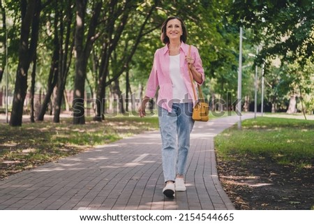 Photo of pretty adorable lady pensioner wear pink shirt walking smiling outdoors countryside garden Сток-фото © 