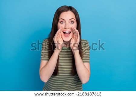 Photo of impressed young brunette lady say gossip wear striped t-shirt isolated on blue color background Foto stock © 