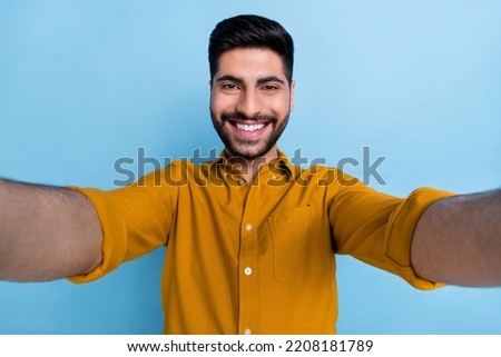 Image, Stock Photo Young man recording himself while playing guitar and singing to share the video in social media. Musician recording a music video at home.