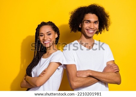 Portrait of attractive lady handsome guy crossed arms toothy smile isolated on yellow color background Foto stock © 
