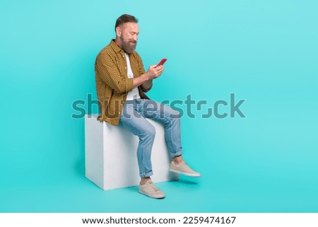 Similar – Image, Stock Photo Man sits on a white horse bridled with a bosal and looks for a carrot in his jacket pocket in thanks for the horse carrying him. In the background are blurred autumn trees.