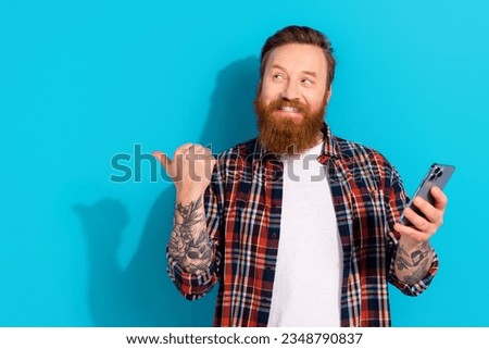 Similar – Image, Stock Photo Brutal man browsing smartphone in backyard