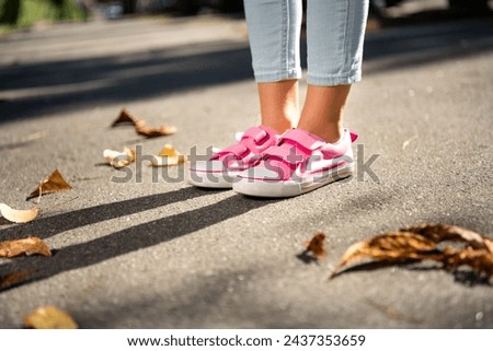 Similar – Image, Stock Photo Little girl walks by the hand of her mother and looks back smiling with a swing in her hair.