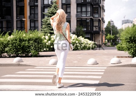 Similar – Image, Stock Photo Rear view blonde woman walking in the evening on field, low sun