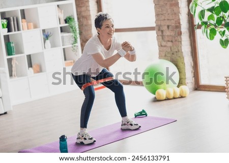 Image, Stock Photo Woman with resistance band on wrists working out at home