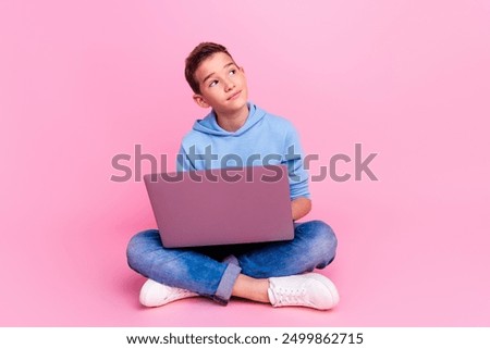 Similar – Image, Stock Photo Boy sitting on a sofa with headphones on his head and using the laptop