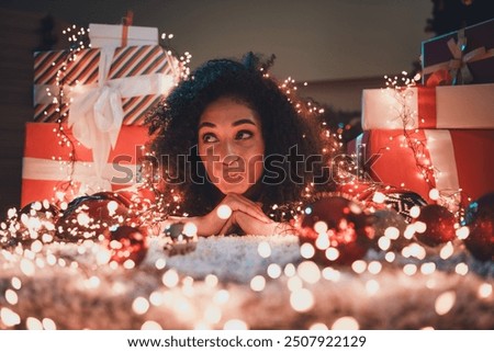 Similar – Image, Stock Photo woman in a Santa hat with lighted sparklers on the background of a New Year or Christmas tree decorated with red ball.