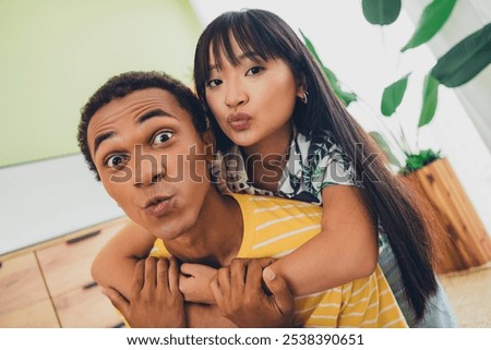 Similar – Image, Stock Photo Positive multiethnic couple embracing on street