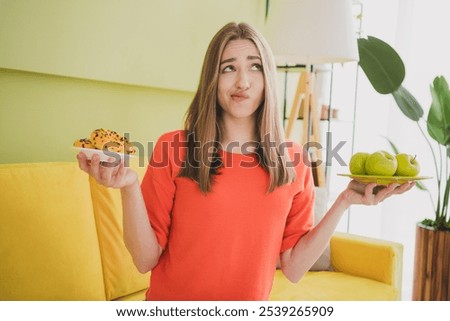 Similar – Foto Bild Skeptisches Mädchen isst Obst im Garten