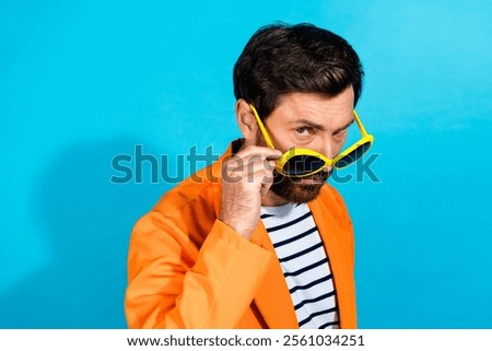 Similar – Image, Stock Photo Trendy young guy adjusting futuristic sunglasses in neon studio