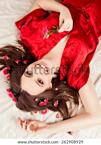 girl with a circlet of flowers on head. charming girl with a flowers. young woman has a beautiful face.