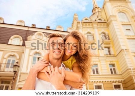 Happy couple in love on the background of buildings