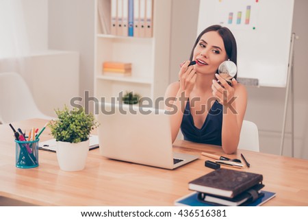 Pretty happy businesswoman doing make up in office Сток-фото © 