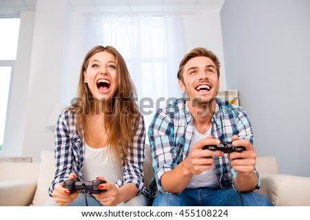 Similar – Image, Stock Photo Cheerful women playing videogame on couch