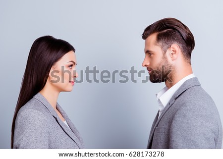 Concept of confrontation in business. Close up photo of two young serious confident people standing face-to-face to each other ストックフォト © 