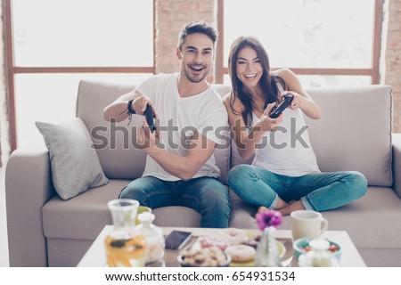 Similar – Image, Stock Photo Cheerful women playing videogame on couch