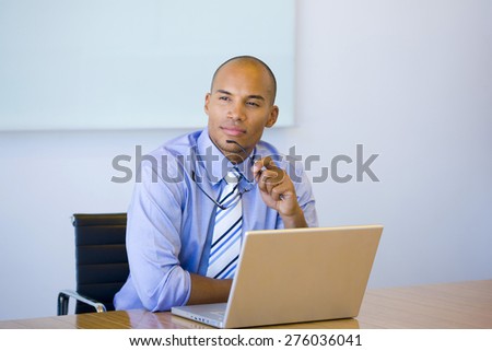 Business executive thinking in front of his laptop.