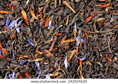 Tea black, large leaf, flowers with red saffron, blue cornflowers and red currant berries