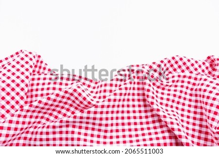 Checkers fabric crumpled top view with copy space. Red and white tablecloth texture picnic isolated on white background. Stock fotó © 