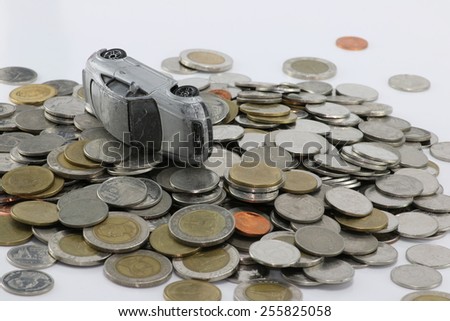 Gray car accident on a pile of money white background. to pay damages.
