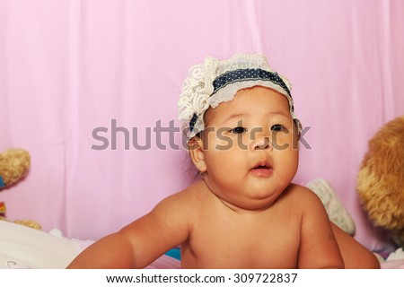 The little baby girl with blue hair band.