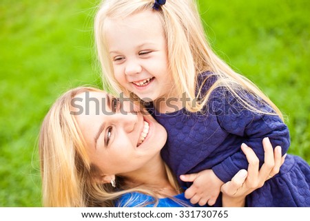 Young Beautiful Blonde Mother And Her Cute Little Daughter Smiling And ...