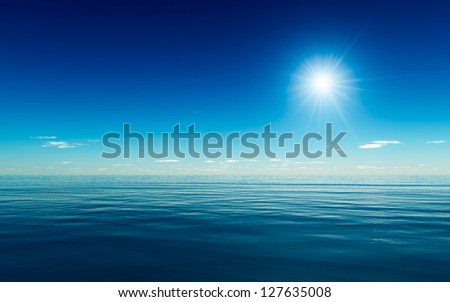 Gentle blue ocean with a bright sun flare