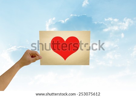 paper in man hand in love on natural background There is space for you to add your text.