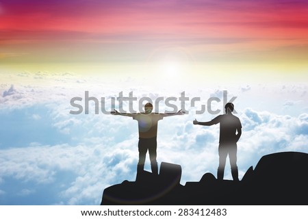 Silhouette of the 2 real friend on the peak of mountain.Everyone need real friends