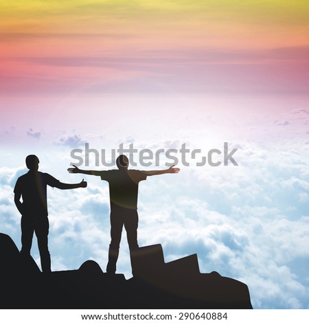 Silhouette of the 2 real friend on the peak of mountain.Everyone need real friends