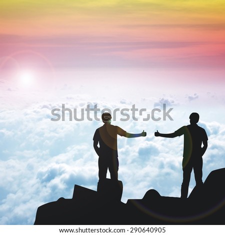 Silhouette of the 2 real friend on the peak of mountain.Everyone need real friends