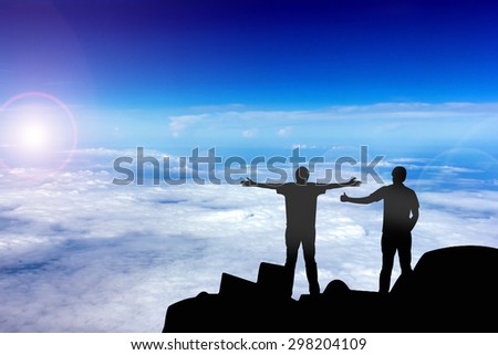 Silhouette of the real friend on the peak of mountain.Everyone need real friends