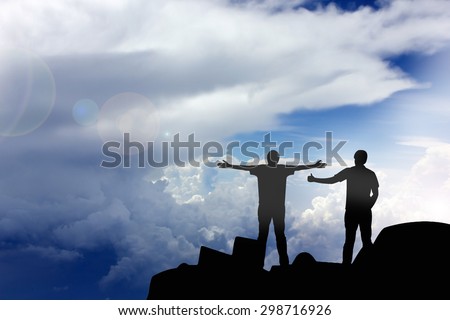 Silhouette of the real friend on the peak of mountain.Everyone need real friends
