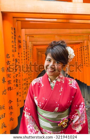 KYOTO, JAPAN - 19 April 2015: Fushimi Inari Shrine The kimono is the national costume of Japan, The tourist popular to rent a kimono for take pictures with memorable landmarks in Japan.