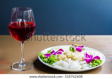 close-up of rice noodles and wine on Blue Background