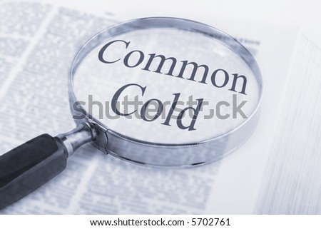 Dictionary with magnifying glass emphasising the words Common Cold.
