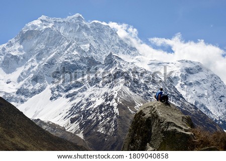 Similar – Image, Stock Photo Traveler contemplating snowy ridge in sunlight