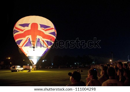 NORTHAMPTON, ENGLAND - AUGUST 18: Hot Air Balloon with british flag doing night time show at the Northampton Balloon Festival, on August 18, 2012 in Northampton, England.