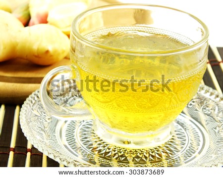 ginger drink and ginger root on wooden table