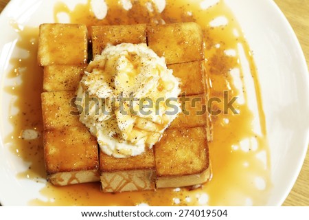 Honey bread with cream on white dish.