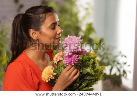 Similar – Image, Stock Photo Young woman smelling flower in the field