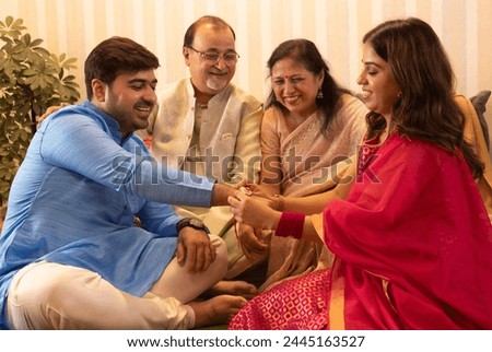 Similar – Image, Stock Photo Sister and brother relaxing at home and using netbook