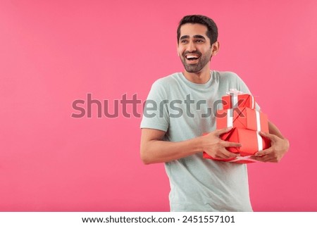 Similar – Image, Stock Photo Young man holding a small plant of cactus with his left hand. He’s in the center of the image. The background is yellow. The cactus is inside a brown vase