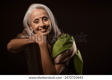 Similar – Image, Stock Photo fit senior lady dressed in black by the lake