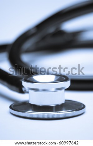 Blue-toned stethoscope with shallow focus on the foreground